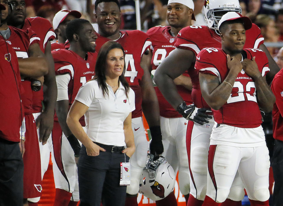 FILE - In this Aug. 22, 2015, file photo, Arizona Cardinals training camp coach Jen Welter watches from the sidelines during the second half of an NFL game against the San Diego Chargers in Glendale, Ariz. Praising the coaches and players for accepting her without reservation, Jen Welker is proud she's opened another door for women in men's professional sports as the first female coach of any kind on an NFL team. (AP Photo/Matt York, File)