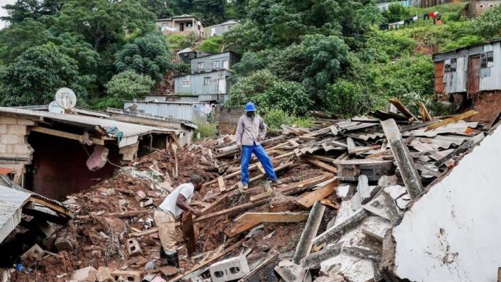 Man standing on debris in Clermont, near Durban