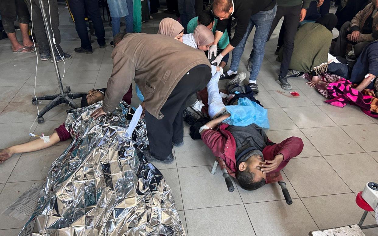 Palestinians wounded in an Israeli strike while waiting for humanitarian aid on the beach in Gaza City