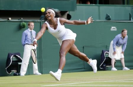 Serena Williams of the U.S.A. reacts as she reaches for the ball during her match against Heather Watson of Britain at the Wimbledon Tennis Championships in London, July 3, 2015. REUTERS/Suzanne Plunkett
