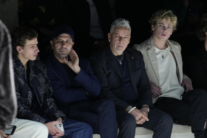 Former soccer player Roberto Baggio, second from right, is flanked at left by actor Checco Zalone during the Emporio Armani menswear Fall-Winter 2023-24 collection presented in Milan, Italy, Saturday, Jan. 14, 2023. (AP Photo/Luca Bruno)