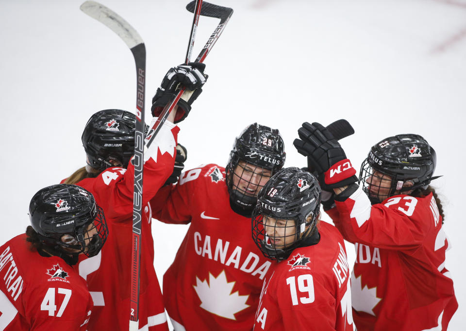 Canada's Marie-Philip Poulin (29) celebrates her goal against Finland with teammates during the second period of an IIHF women's hockey championship game in Calgary, Alberta, Friday, Aug. 20, 2021. (Jeff McIntosh/The Canadian Press via AP)