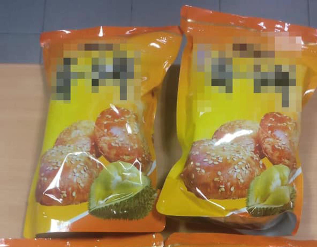 ICA officers at Woodlands Checkpoint separately caught two travellers attempting to smuggle bak kwa (barbecued meat), hidden in packets of durian-flavoured biscuits. (PHOTO: ICA / Facebook)