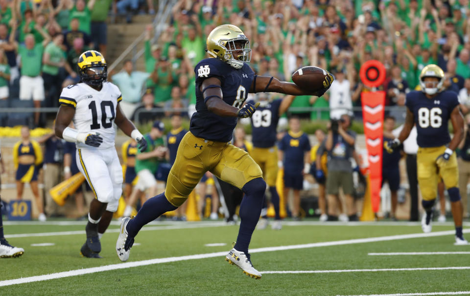 Notre Dame wide receiver Jafar Armstrong (8) scores a touchdown in front of Michigan linebacker Devin Bush (10) in the first half of an NCAA football game in South Bend, Ind., Saturday, Sept. 1, 2018. (AP Photo/Paul Sancya)