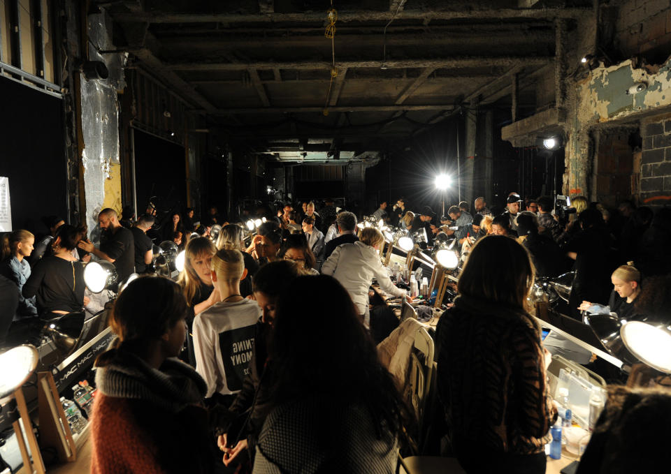 Models get ready backstage before the Donna Karan New York Fall 2014 collection is presented during Fashion Week, Monday, Feb. 10, 2014, at 23 Wall Street in New York. (AP Photo/Diane Bondareff)