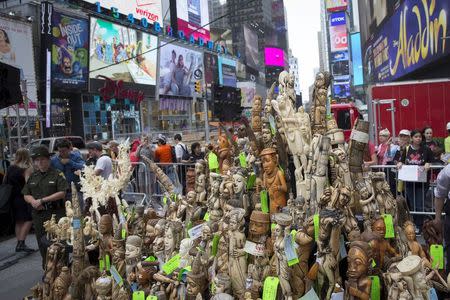 Carved pieces of confiscated ivory are placed out to be crushed in New York's Times Square June 19, 2015. REUTERS/Brendan McDermid