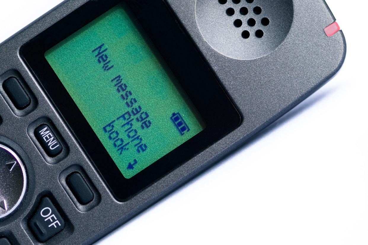 Closeup of older cell phone screen with 'New Message', diagonal, on a white background