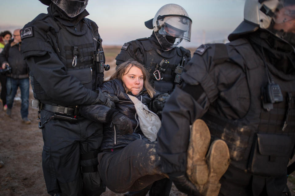 ERKELENZ, GERMANY – JANUARY 17: Police officers detain climate activist Greta Thunberg at a demonstration against the expansion of the Garzweiler coal mine near the village of Luetzerath on January 17, 2023 in Erkelenz, Germany. The demonstrators were held by police for hours before they had to go through identity check and were put in a bus. (Photo by Hesham Elsherif/Getty Images)