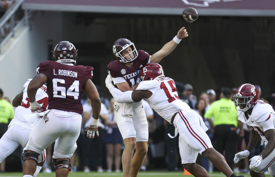 Oct 7, 2023; College Station, Texas; Texas A&M Aggies quarterback Max Johnson (14) attempts a pass as Alabama Crimson Tide linebacker Dallas Turner (15) applies defensive pressure during the fourth quarter at Kyle Field. Troy Taormina-USA TODAY Sports
