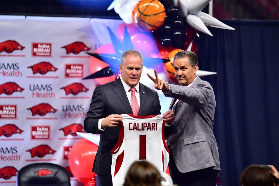 Arkansas basketball coach John Calipari (right) is introduced to Razorbacks fans by athletic director Hunter Yurachek on April 10, 2024.