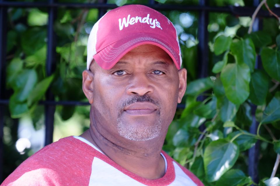 P Foster stands outside the Lake Grove Village Apartments on Chicago's South Side on June 9, 2021. Tionda and Diamond Bradley were living in the apartments at the time of their disappearance 20 years ago.