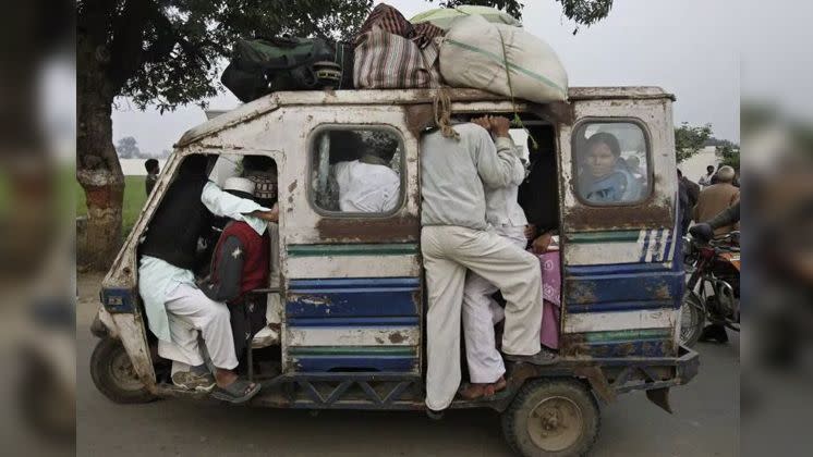 This motorised rickshaw is crammed full of people as it makes its way down a street in India. Photo: Reuters