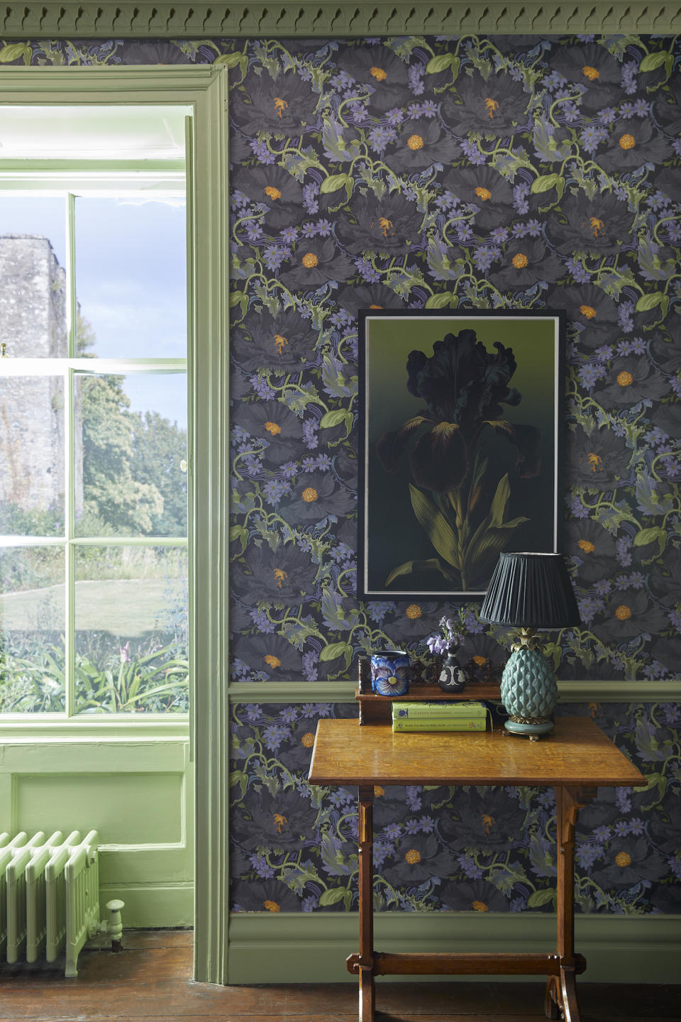 A hallway with poppy wallpaper and green trim