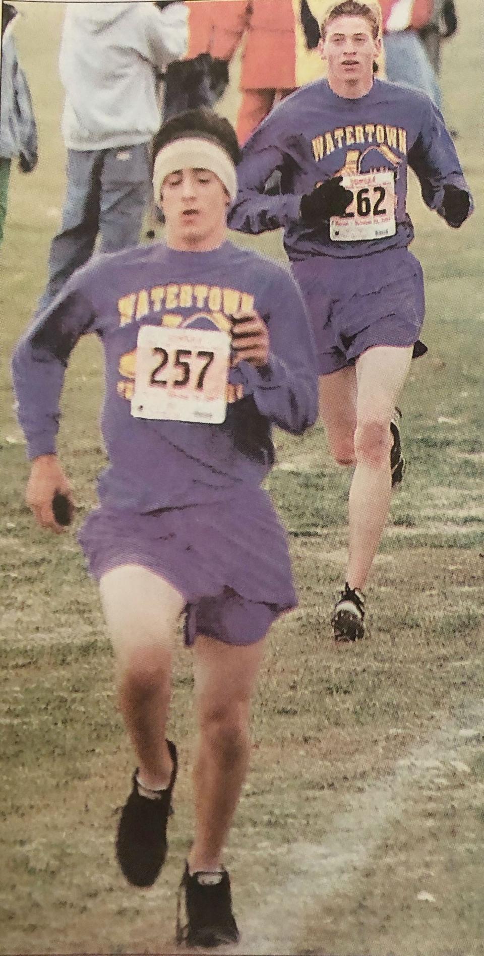 Watertown runners Kasey Hoffman and A.J. Shultz sprint to the finish line in the Class AA boys' race during the 2003 state cross country meet at Huron.