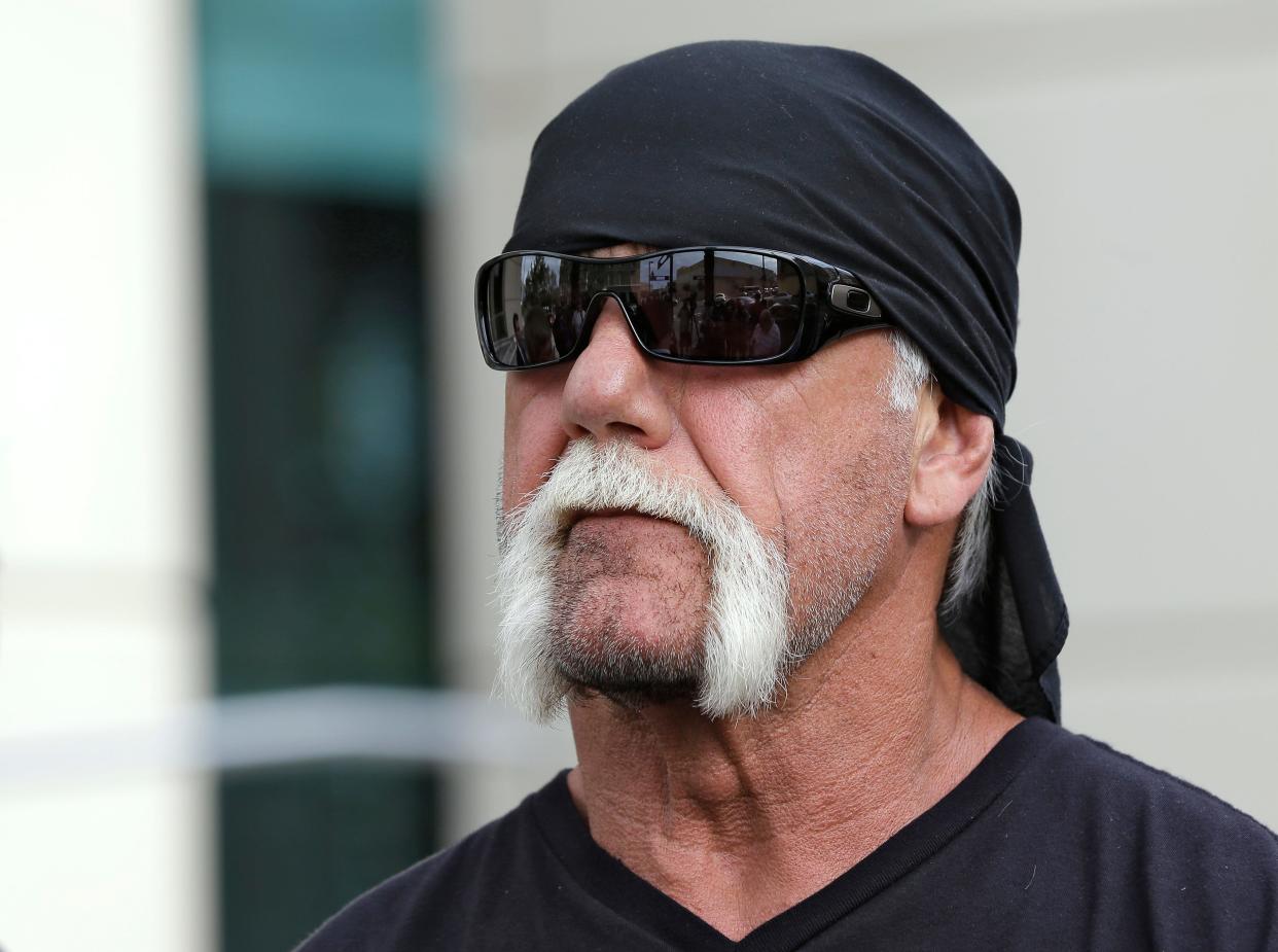 In this Oct. 15, 2012, file photo, reality TV star and former pro wrestler Hulk Hogan, whose real name is Terry Bollea, looks on as his attorney speaks in Tampa World Wrestling Entertainment Inc. has reinstated Hogan to its Hall of Fame, three years after he was found to have used racial slurs in a conversation caught on a sex tape. (AP Photo/Chris O'Meara, File)