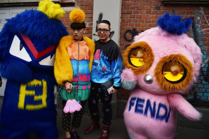 Fendi mascots, or Fendirumi, Bug-Kun (L) and Piro-chan (R) pose in the street during Milan Fashion Week on February 25, 2016 (AFP Photo/Gabriel Bouys)