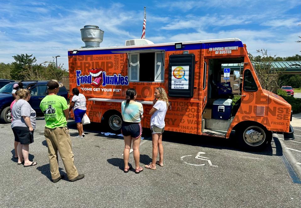 Food Junkies, a food truck based in Miami, serves free hot meals on Sept. 6, 2023, in Mayo, Florida, to residents hit by Hurricane Idalia. The food truck and others are providing meals through the nonprofit World Central Kitchen.