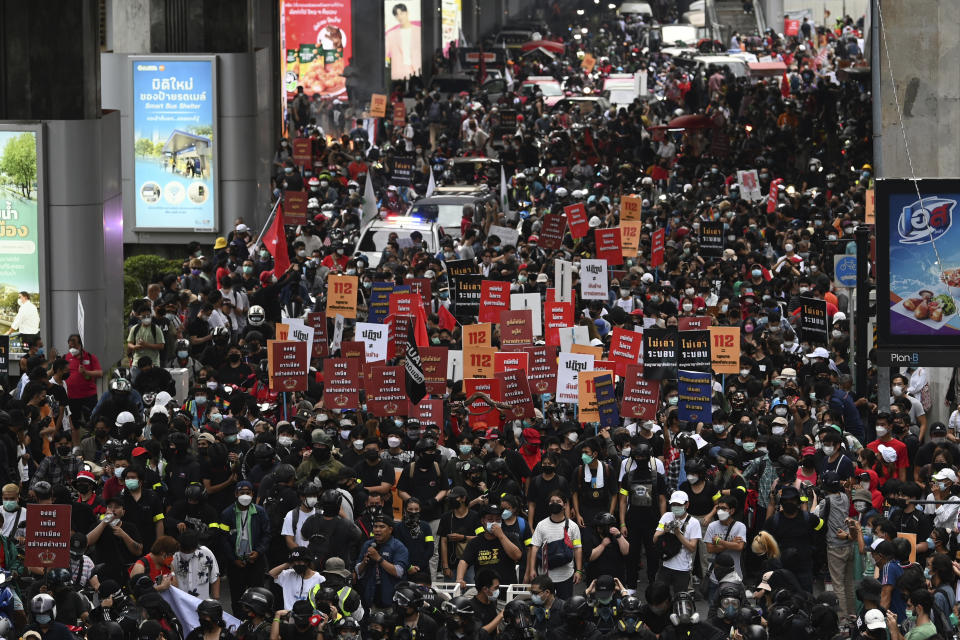 Anti-government protesters hold banners calling for the monarchy reform marching to the German embassy in Bangkok, Thailand, Sunday, Nov. 14, 2020. Protesters calling for the reform of the monarchy returned to the streets of Bangkok despite the ruling of the Constitutional Court on Wednesday that such demands are tantamount to attempting to overthrow the system of government with the king as head of state. (AP Photo/Surat Sappakun)