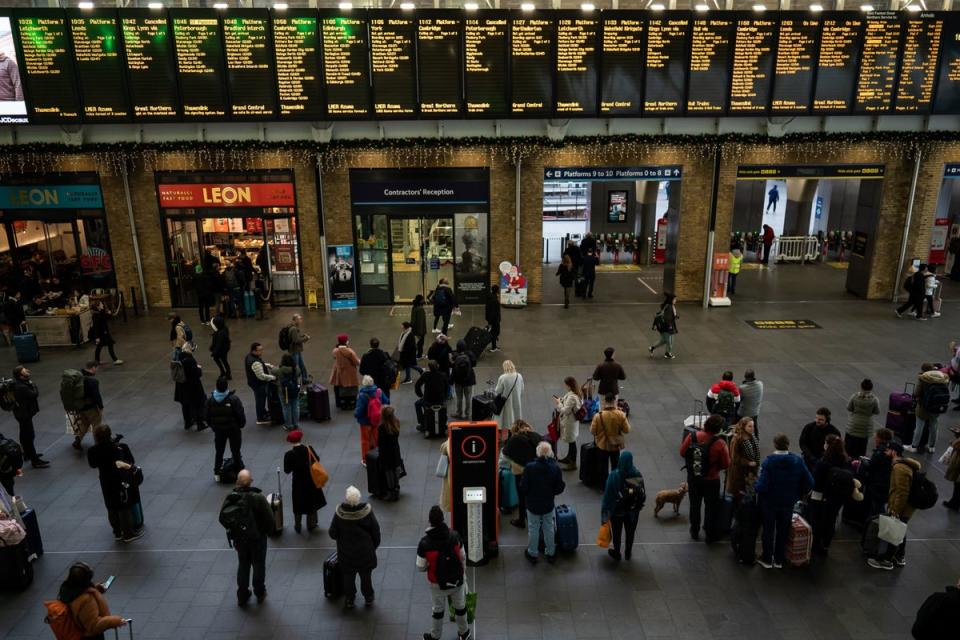 People prepare to board trains at Kings Cross Station (PA)