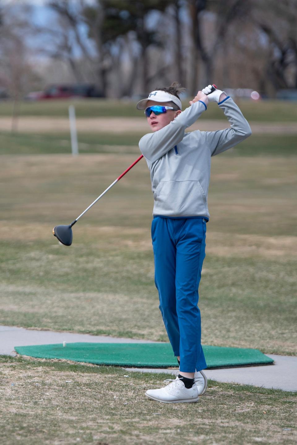 Brady Shaw watches his tee shot on the driving range at Elmwood Golf Course on Monday, March 27, 2023.