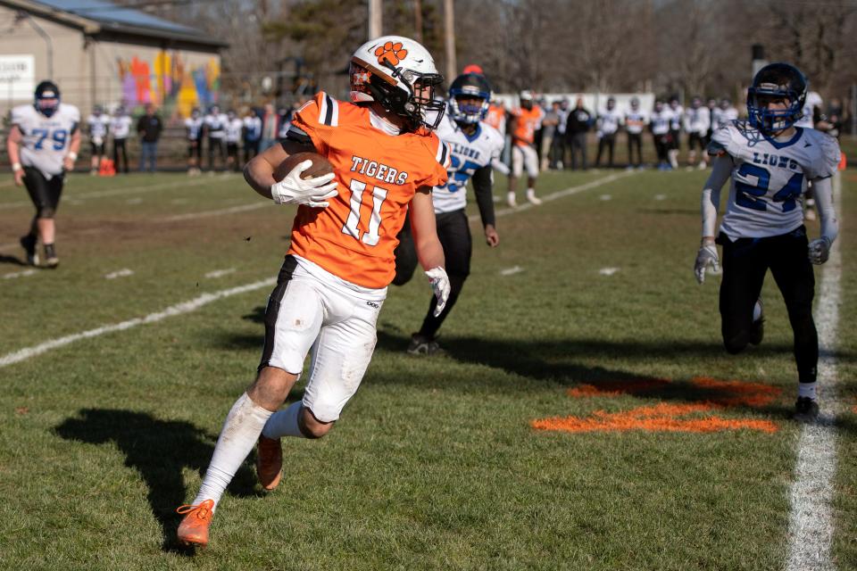 Maynard/AMSA junior Mateo Arrellano carries the ball down the field during the Thanksgiving Day game against Wet Boylston at Alumni Field in Maynard, Nov. 24, 2022. The Tigers defeated the Lions, 48-13.