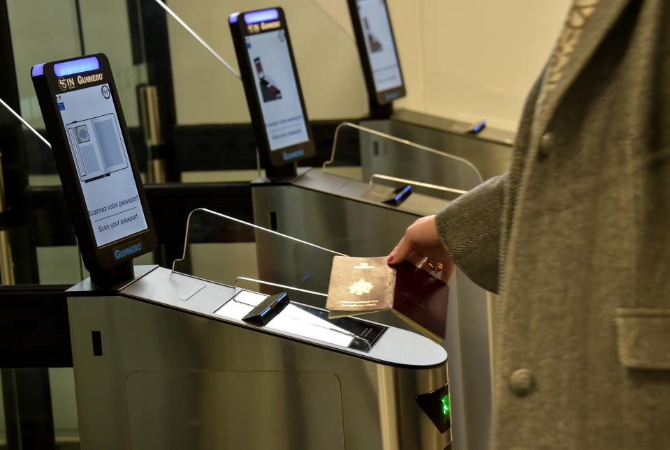 A woman scans her passport at an automated kiosk on March 28, 2019 at the Coquelles Eurotunnel border post, a new border inspection post for customs and sanitary control built in anticipation of a no-deal brexit. - Under EU rules, animals, fresh food and agri-feed from Britain will be classified as being from a third country post Brexit, with checks for disease, traceability, rules of origin and welfare mandatory on the French side. (Photo by Philippe HUGUEN / AFP)        (Photo credit should read PHILIPPE HUGUEN/AFP/Getty Images)