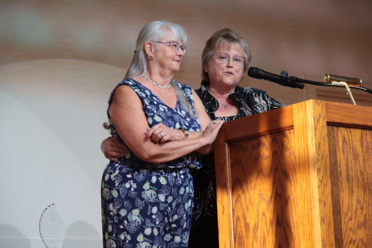 Wendy Pizaña of County National Bank, right, introduces Marty Schoonover of Len-Air LLC, the Greater Lenawee Chamber of Commerce's Ambassador of the Year, during the chamber's awards ceremony May 1 at the Adrian Armory Events Center.