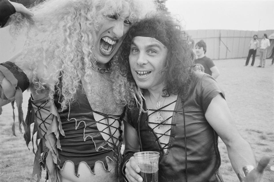 <p>Dee Snider from Twisted Sister and Ronnie James Dio from Rainbow, Black Sabbath, and Dio pose backstage at the Donnington Festival on August 20, 1983.</p>