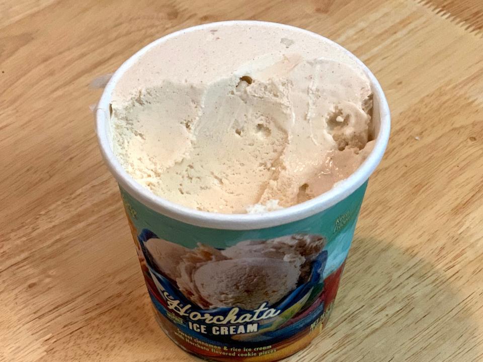 Colorful, open carton of Trader Joe's horchata ice cream on wood table
