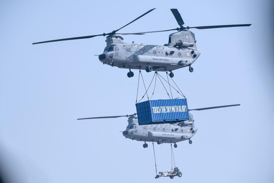 Indian Air Force (IAF) Chinook helicopters transport a freight during the 88th Air Force Day parade at Hindon Air Force station in Ghaziabad on October 8, 2020. (Photo by Money SHARMA / AFP) (Photo by MONEY SHARMA/AFP via Getty Images)