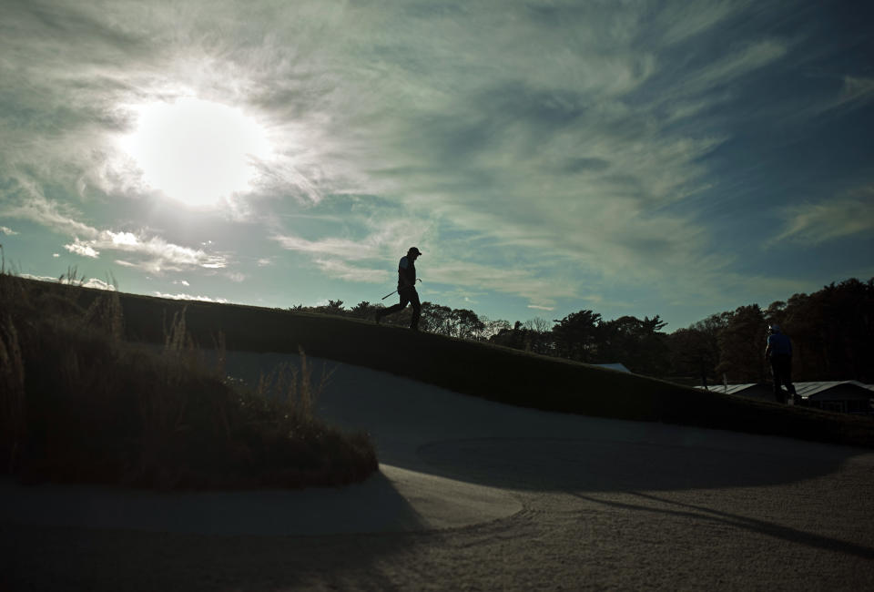 Phil Mickelson walks down to hit out of a bunker on the 18th fairway during the first round of the PGA Championship golf tournament, Thursday, May 16, 2019, at Bethpage Black in Farmingdale, N.Y. (AP Photo/Andres Kudacki)