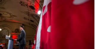 Canadian Prime Minister-designate Justin Trudeau with flag [photo: Liberal.ca]