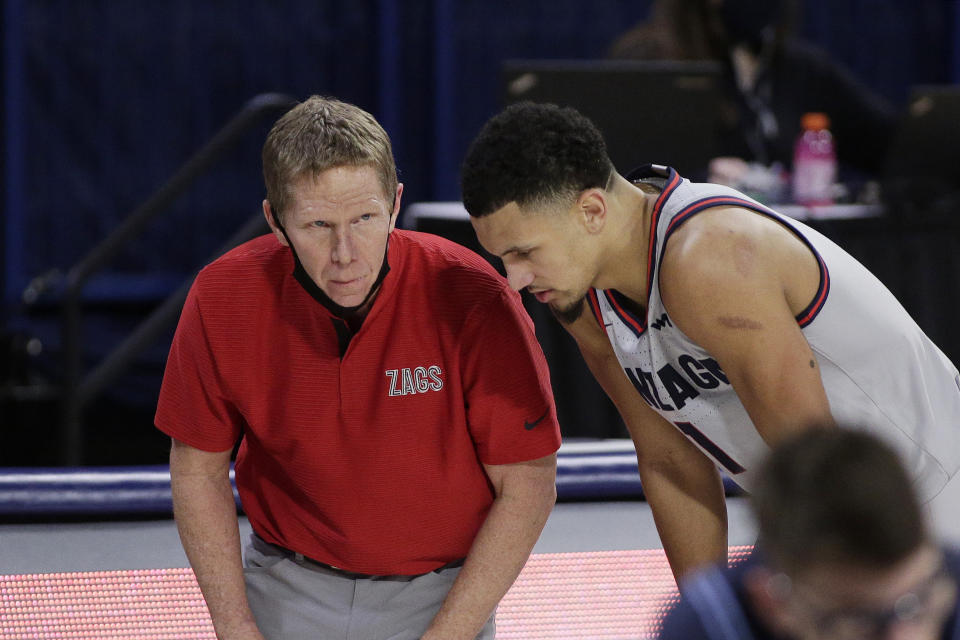 Gonzaga coach Mark Few, left, speaks with guard Jalen Suggs during the second half of the team's NCAA college basketball game against San Diego in Spokane, Wash., Saturday, Feb. 20, 2021. (AP Photo/Young Kwak)