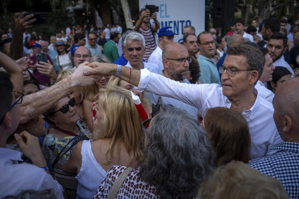 Popular Party candidate Nunez Feijoo cheers supporters during a campaign meeting in Barcelona, Spain, Monday, July 17, 2023. The conservative Popular Party candidate for Sunday's general election is mostly unknown outside Spain, but he has been the country's most solid regional leader so far this century and has never lost an election. (AP Photo/Emilio Morenatti)