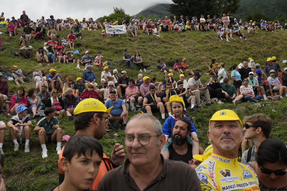 Spectators wait at the finish line during the fifth stage of the Tour de France cycling race over 163 kilometers (101 miles) with start in Pau and finish in Laruns, France, Wednesday, July 5, 2023. (AP Photo/Thibault Camus)