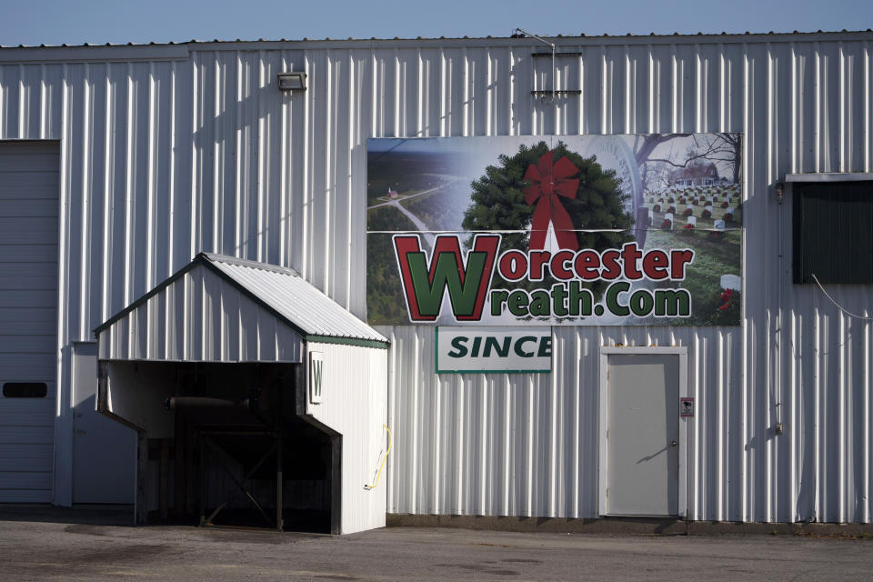 A sign is seen on a Worcester Wreath building in Columbia Falls, Maine, Thursday, April 27, 2023. In 1992, Morrill Worcester began providing thousands of balsam wreaths to adorn headstones at Arlington. That continued quietly for years until photos showing the cemetery wreaths against a backdrop of snow went viral. The annual effort became so big that its nonprofit spinoff, Wreaths Across America, run by his wife, now provides more than 1 million wreaths to military cemeteries and gravesites. (AP Photo/Robert F. Bukaty)
