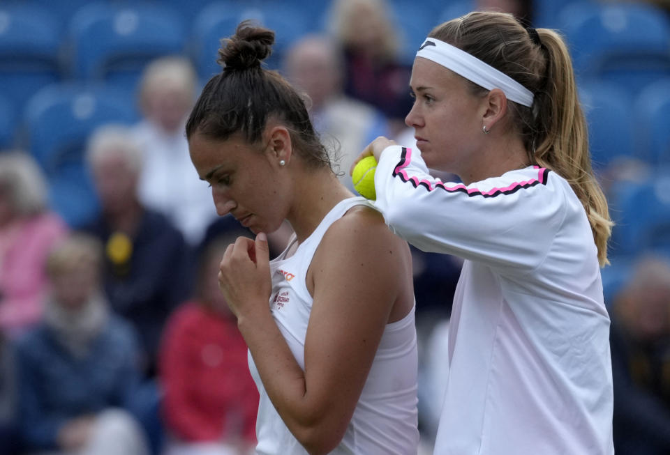 Marie Bouzkova of Czech Republic, right, and Sara Sorribes Tormo of Spain talk during their doubles tennis match against Serena Williams of the United States and Ons Jabeur of Tunisia at the Eastbourne International tennis tournament in Eastbourne, England, Tuesday, June 21, 2022. (AP Photo/Kirsty Wigglesworth)