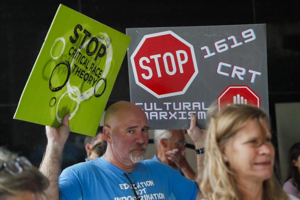 A man protests against critical race theory curriculum in Ohio schools on Tuesday, Sept. 21, 2021 outside the State Board of Education building in Columbus, Ohio.