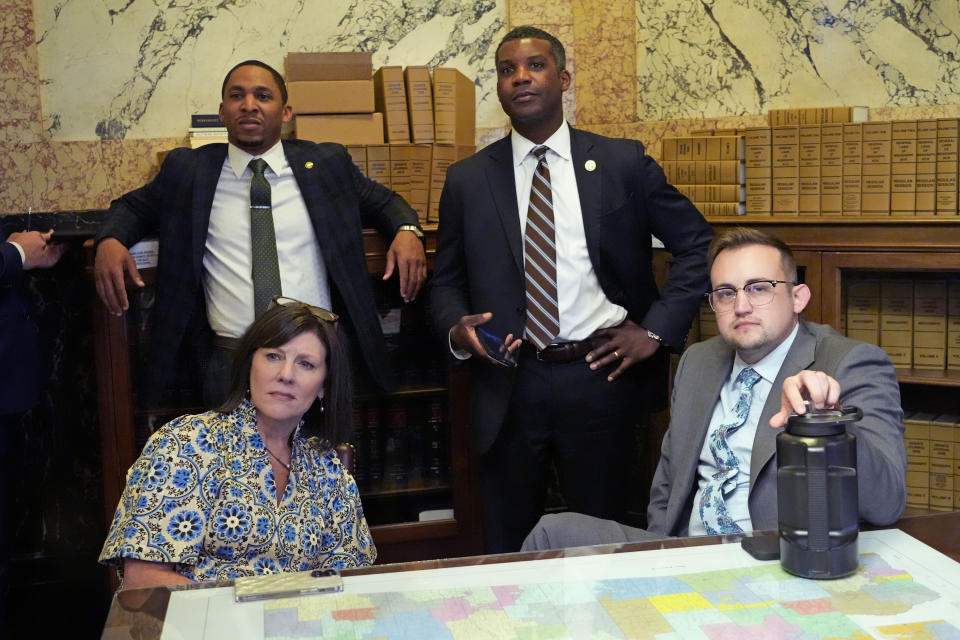 Mississippi State House Medicaid Committee Chairman Rep. Missy McGee, R-Hattiesburg, seated left, state Rep. Jansen Owen, R-Poplarville, seated right, and state Rep. Rodney Hall, R-Southaven, back right, join state Sen. Bradford Blackmon, D-Canton, back left, in listening to the debate over a proposed Medicaid expansion bill in the Senate Chamber at the state Capitol in Jackson, Miss., Thursday, March 28, 2024. (AP Photo/Rogelio V. Solis)