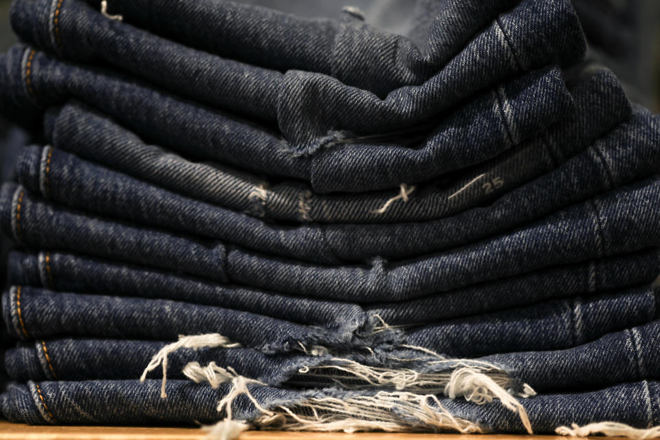 A stack of ripped blue jeans.