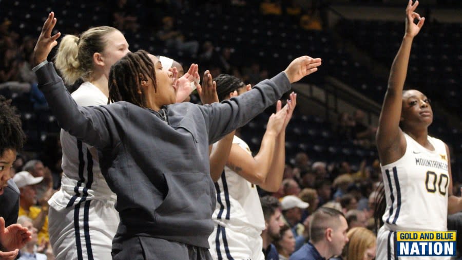 WVU guard Zya Nugent (forward) and other teammates celebrate a made three-pointer in the first half of West Virginia’s season opener. (Photo Ryan Decker, Gold and Blue Nation)