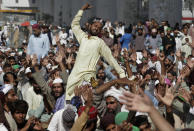 Supporters of Tehreek-e-Labiak Pakistan, a radical Islamist political party, chant slogans prior to start their march toward Islamabad, in Lahore, Pakistan, Friday, Oct. 22, 2021. Thousands of Islamists launched their "long march" from the eastern city of Lahore toward Pakistan's capital, demanding that the government release the leader of their Saad Rizvi, who was arrested last year amid demonstrations against France over publishing caricatures of Islam's Prophet Muhammad. (AP Photo/K.M. Chaudary)