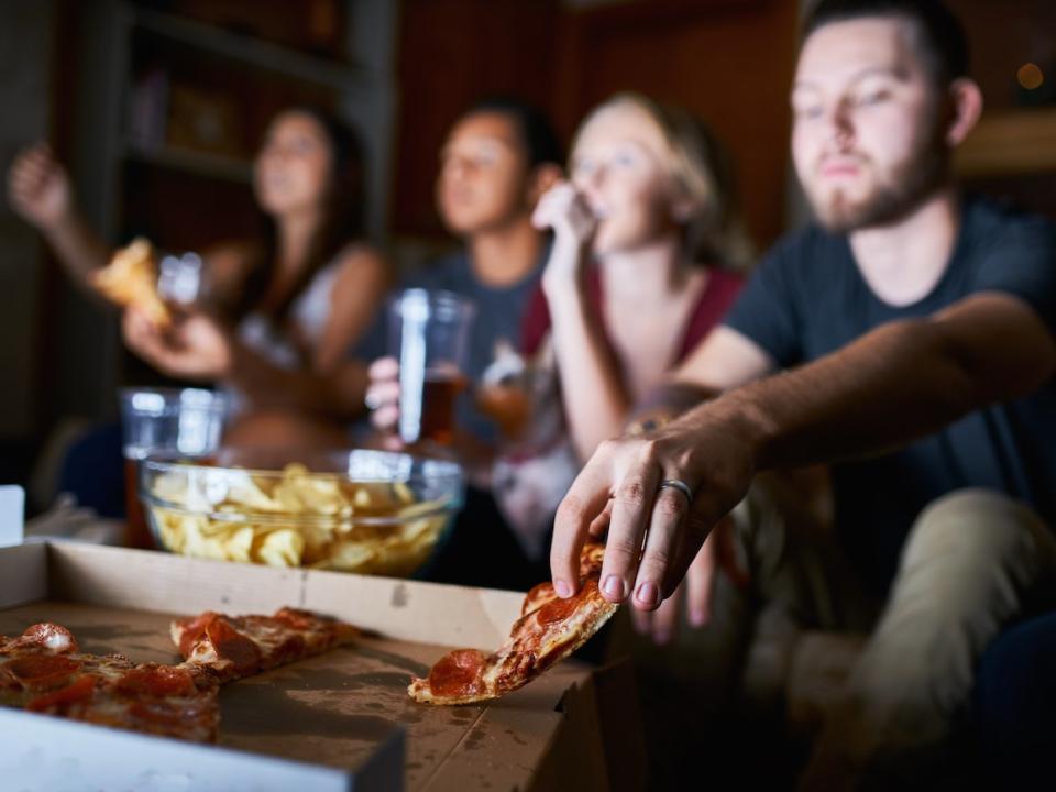 friends eating pizza watching tv movies