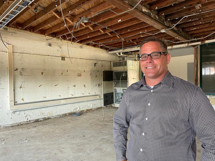 Howell developer Chris Bonk poses in a room that will become the mall for The Means Project on September 7, 2021 at 935 W. Main St. in Pinckney