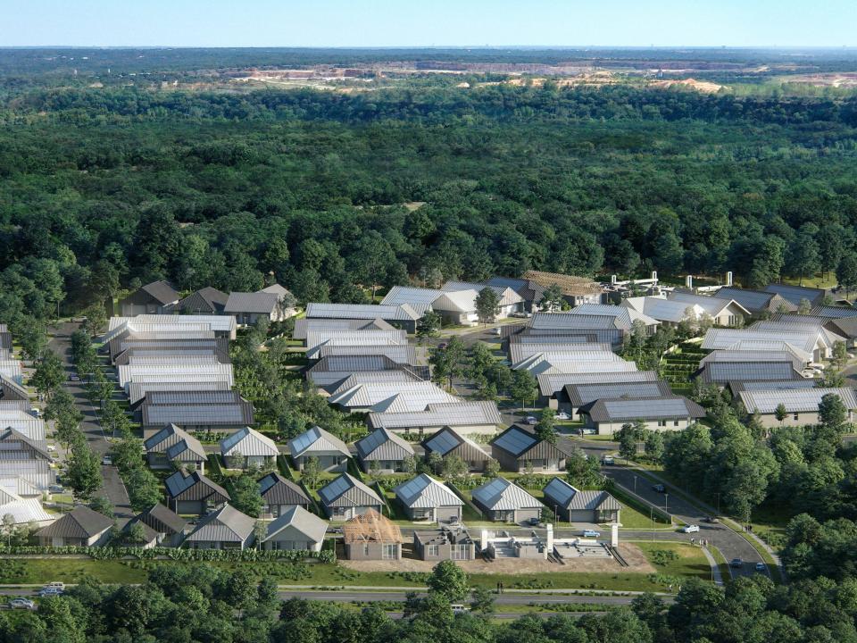 rendering of the 100-home 3D-printed community surrounded by trees