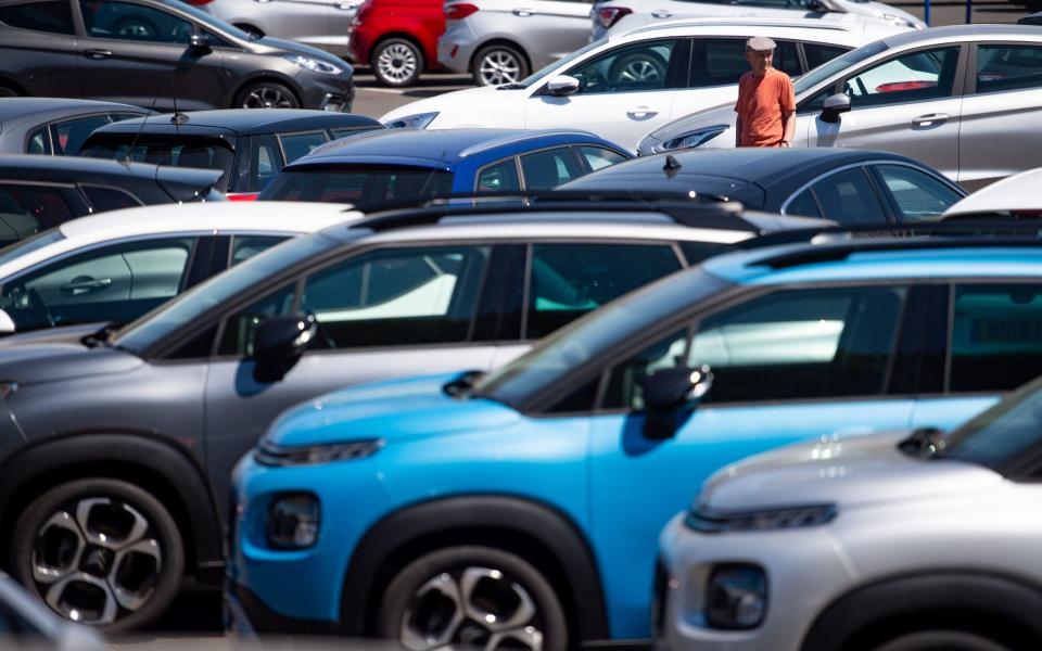 people view cars on the forecourt at Motorpoint showroom in Oldbury, West Midlands: Monday June 1, 2020 - Jacob King/PA