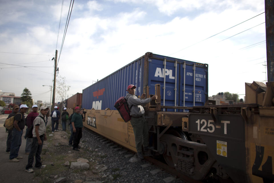 In this May 17, 2012 photo, migrants, mostly from Honduras, wait for a train going north in Lecheria, on the outskirts of Mexico City. While the number of Mexicans heading to the U.S. has dropped dramatically, a surge of Central American migrants is making the 1,000-mile northbound journey this year, fueled in large part by the rising violence brought by the spread of Mexican drug cartels. (AP Photo/Alexandre Meneghini)