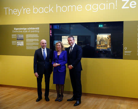 General of the Italian Finance Police Gianluigi D'alfonso, Museum director Axel Ruger and Dutch Minister of Education, Culture and Science Jet Bussemaker reveal two recovered paintings by Vincent van Gogh, which were stolen from the museum in 2002, at the van Gogh Museum in Amsterdam, Netherlands March 21, 2017. REUTERS/Michael Kooren