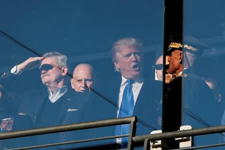 U.S. President-elect Donald Trump speaks with Lieutenant General Robert L. Caslen (R), Superintendent of the United States Military Academy at West Point, as he watches the Army vs Navy college football game at M&T Bank Stadium in Baltimore, Maryland, December 10, 2016. At left is former Republican Party Chairman Jim Nicholson. REUTERS/Mike Segar