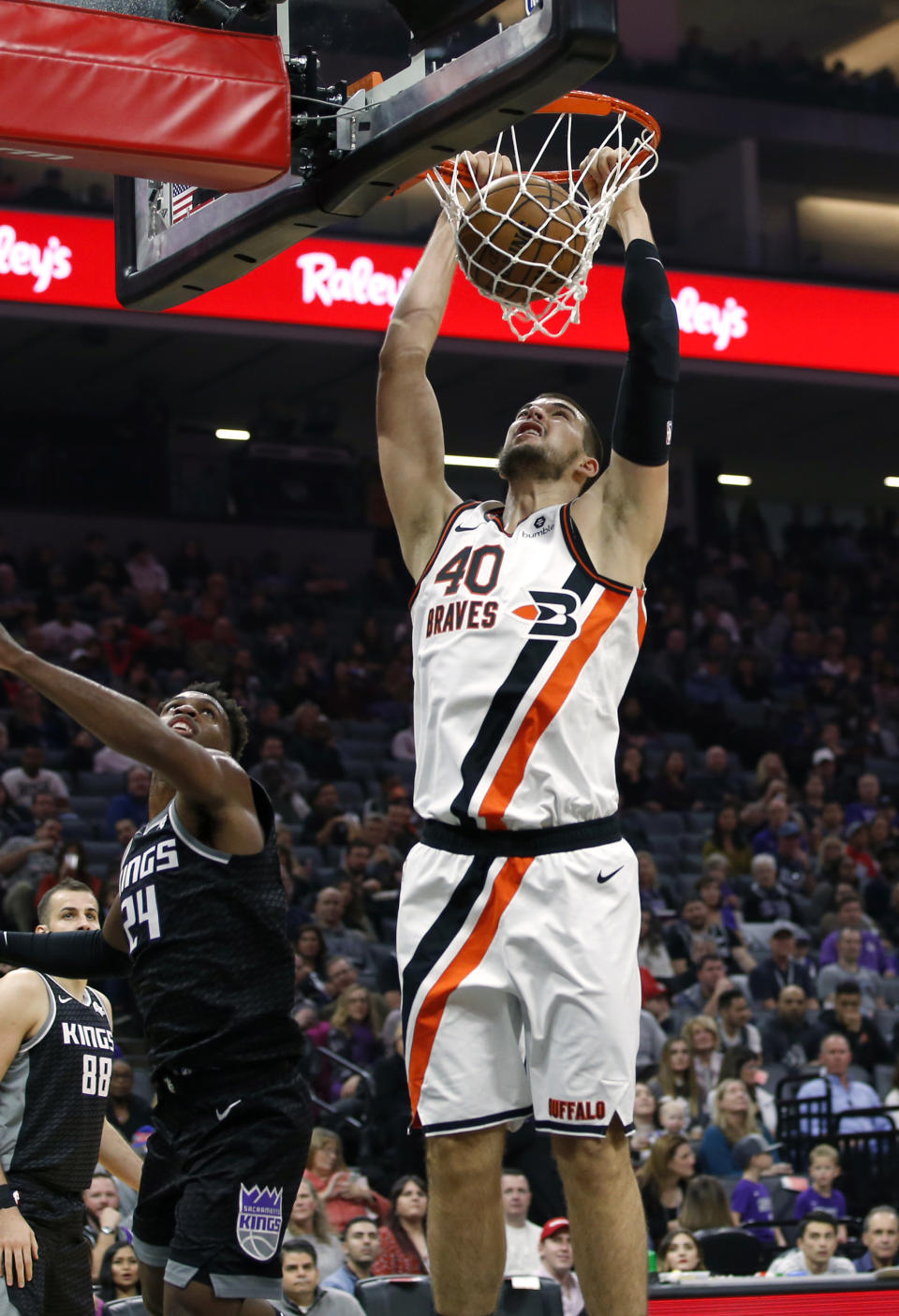 Los Angeles Clippers center Ivica Zubac, right, dunks over Sacramento Kings guard Buddy Hield, left, during the first half of an NBA basketball game in Sacramento, Calif., Tuesday, Dec. 31, 2019. (AP Photo/Rich Pedroncelli)